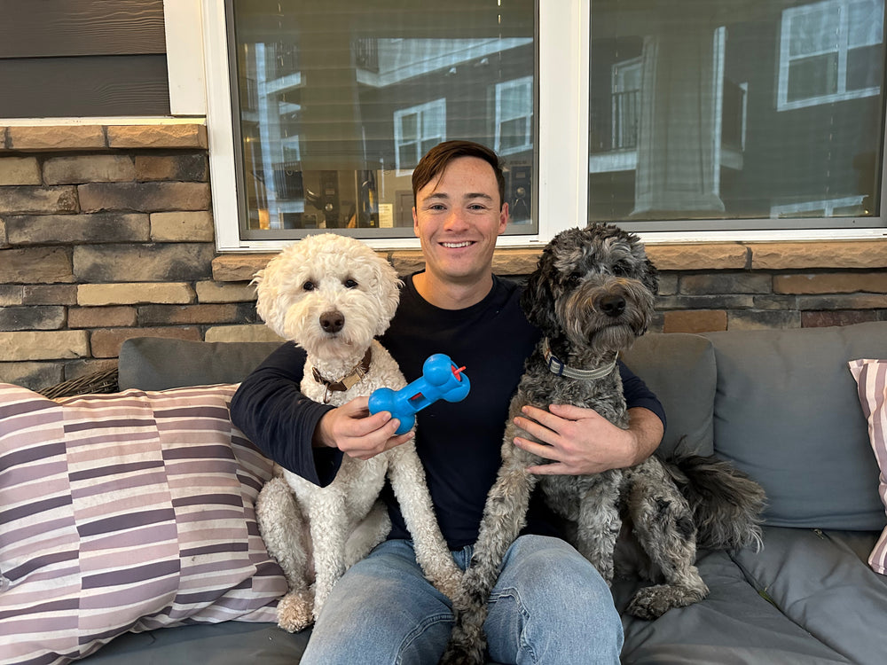 Josh, founder of Nature's Cuts, with his two dogs